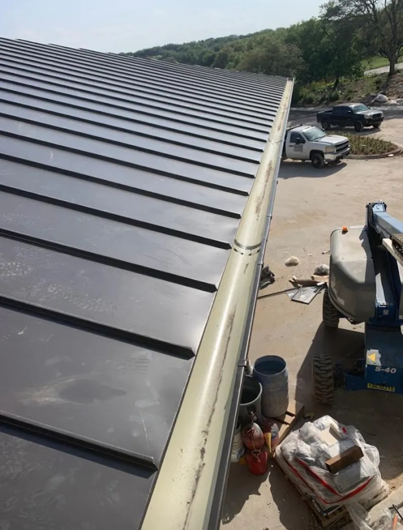 Standing seam panel and gutter detail on a metal roofing jobsite in Wawayanda